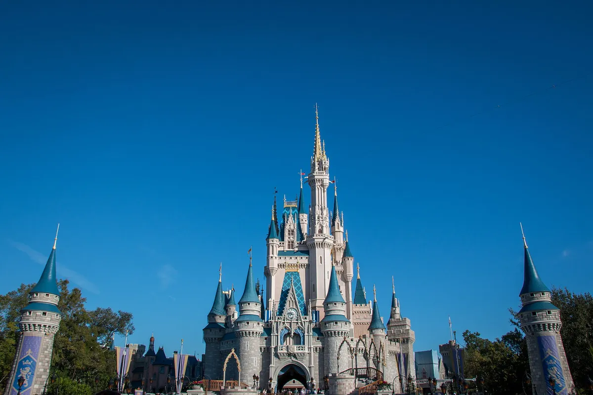 Castelo da Cinderela no Magic Kingdom, com torres azuis sob céu limpo, em registro de 2017.